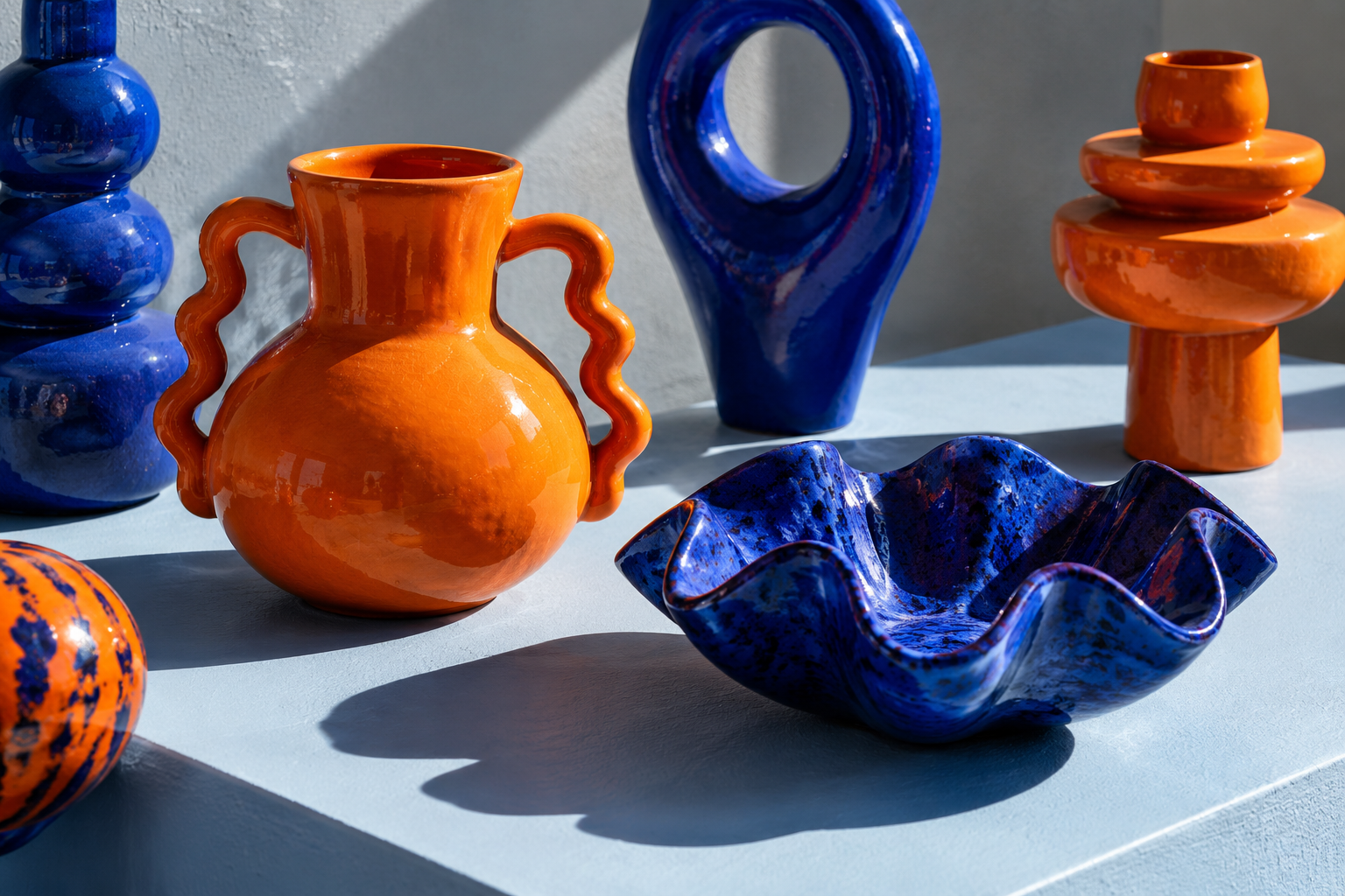 Playful orange and cobalt ceramic pieces made by a neighbourhood ceramicist